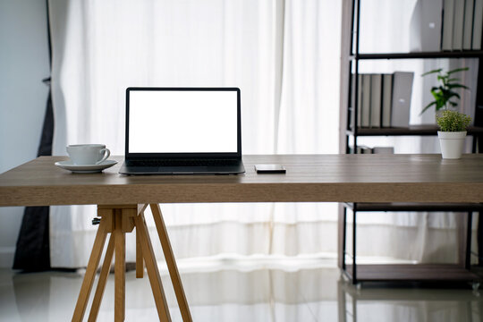 laptop mockup Minimal productivity concept. Clean home office desk, blank screen for UI preview, coffee cup
