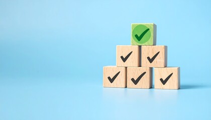 Wooden blocks stacked, green checkmark on top, others with black checkmarks, light blue background