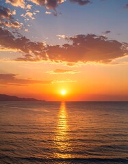 Fototapeta premium Vibrant sunset over calm ocean waters, clouds ablaze with warm hues