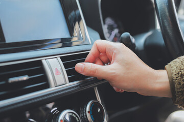 Naklejka premium close up hand air conditioning and center console of car for temperature.