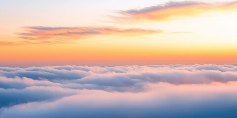 A breathtaking view of a vibrant sunset over a vast expanse of clouds, with the sun setting behind a mountain range in the distance.