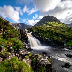 Fototapeta premium Serene landscape of a waterfall cascading through rugged terrain under cloudy skies