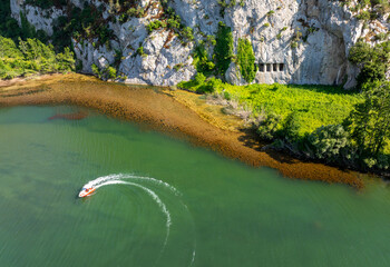 A rocky cliff with ancient Asarkale rock tombs in Bafra, Samsun, Türkiye. Ancient columns carved into the rock. Tourist attractions,