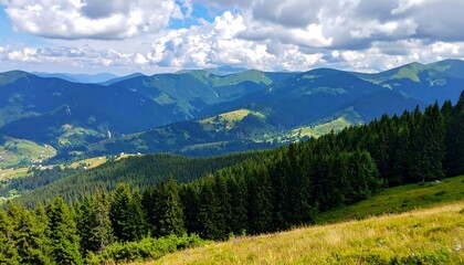 Fototapeta premium Panoramic vista of undulating green mountains under a cloudy blue sky
