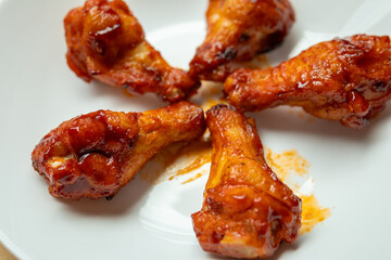 Grilled spicy chicken wing on white plate