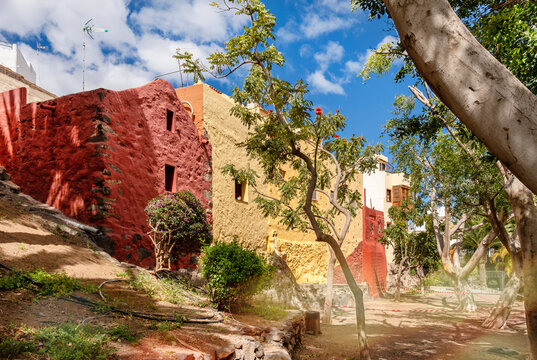 View from Parque Nestor Alamo in Ingenio over colorful historic houses with trees and sunny sky on Gran Canaria.
