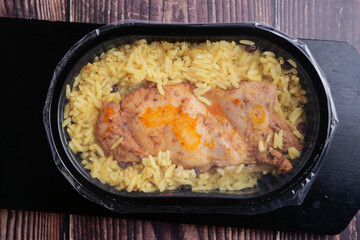 Delicious chicken with rice meal in a clear container