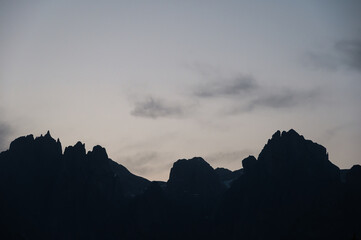Catinaccio mountain rridges silhouette sruring a sunny sunset, Val di Fassa, Trento, Italy