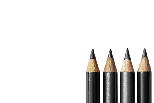 Close-up of three black pencils against a black background