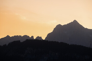 Catinaccio mountain rridges silhouette sruring a sunny sunset, Val di Fassa, Trento, Italy