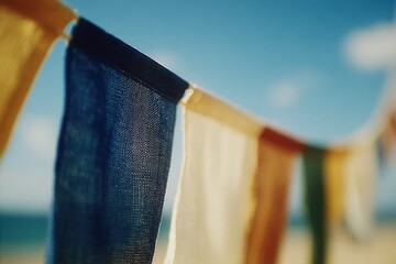 Colorful fabric banners sway gently in warm sunlight against clear blue sky
