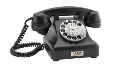 Shiny black rotary phone with coiled cord on dark background