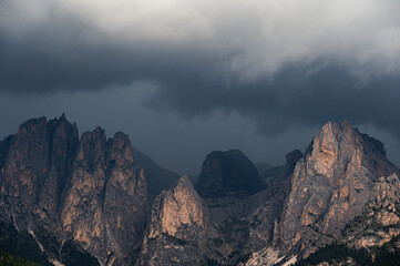 Fototapeta premium moutain Catinaccio range seen from Pozza di Fassa with a cloudy sky in the background, Val di Fassa, Trento, Italy