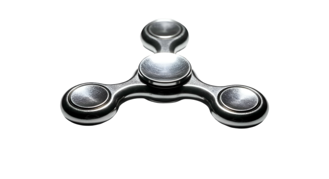 Metal fidget spinner; center focus on toy against dark background