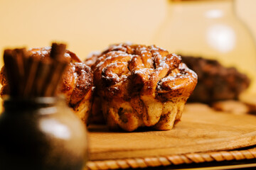 Freshly baked sweet rolls with cinnamon and sugar on a wooden board