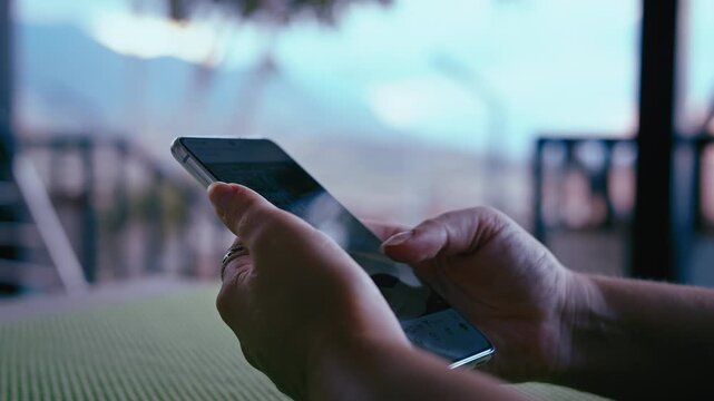 Close-Up of Woman s Hands Using Smartphone on Home Veranda with Scenic Mountain View for Messaging and Reading News