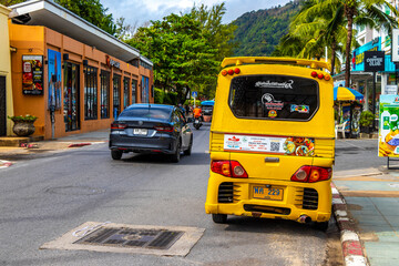 Yellow public transportation tuk tuk car taxi in Phuket Thailand.