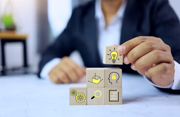 creative concept with businessman arrange wooden block to problem solution working in thinking process or research and development