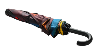 Folded umbrella with colorful panels and curved handle, dark background