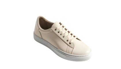 Simple, low-profile cream-colored sneaker on dark backdrop