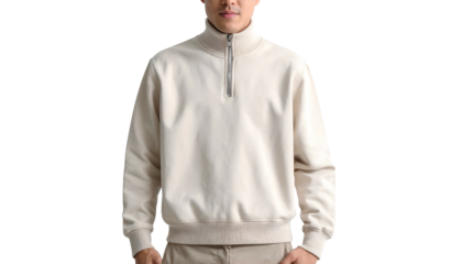 Man in half-zip beige pullover; solid backdrop