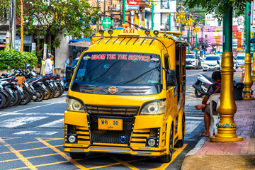 Fototapeta premium Yellow public transportation tuk tuk car taxi in Phuket Thailand.