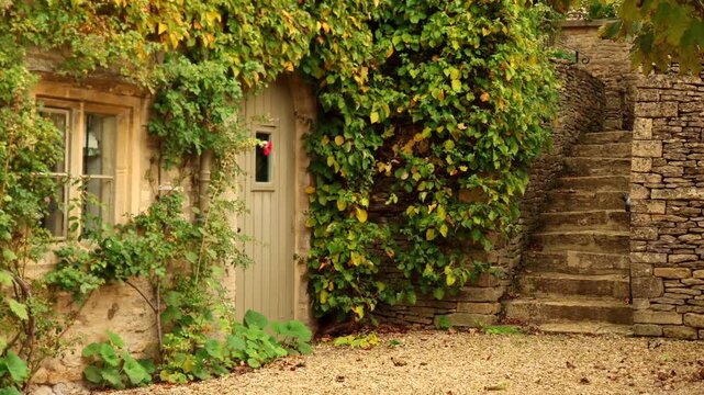 Stone cottage with climbing ivy in the Cotswolds. Cotswolds countryside, England