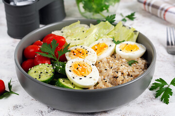 Healthy breakfast Bowl of oatmeal and fresh vegetables.