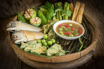 Thai shrimp paste chili dip with fried mackerel and boiled vegetables, traditional Thai food still life (Nam Prik Kapi)