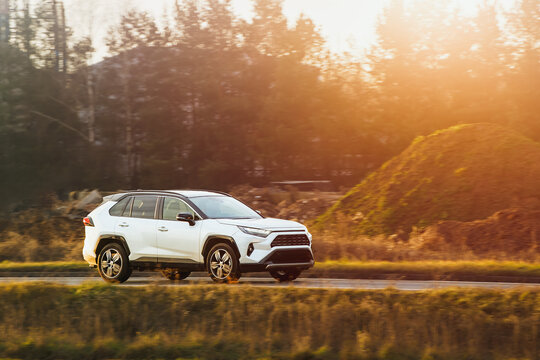 Fototapeta Driving SUV on nature road in autumn