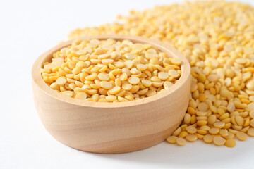 Split soybeans in a wooden cup and on a wooden table. Healthy food concept.