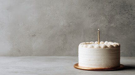 Minimalist birthday cake with smooth white frosting a single gold candle and subtle texture modern elegance
