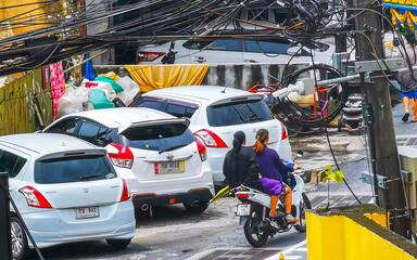 Naklejka premium Patong Phuket Thailand tourist street road with people cars palms.