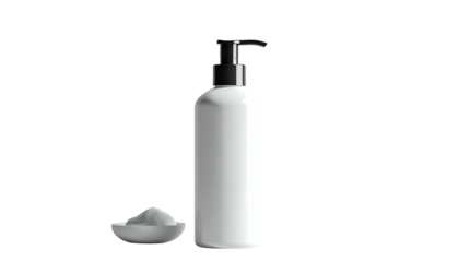 White bottle & dish of powder against a dark background