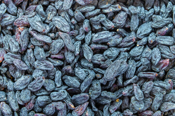 Texture of a large quantity of goji berries. Background of dried barberries. Beautiful berry background with peel texture