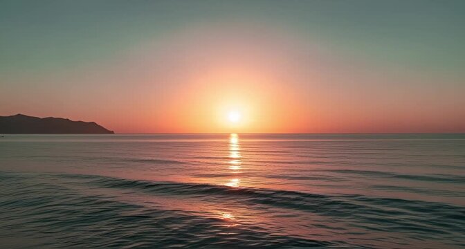 A stunning sunset over the calm ocean, with the sun casting a golden reflection on the gentle waves animated 4k video