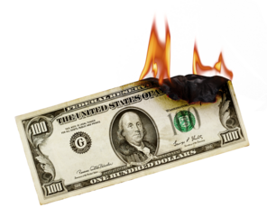 Burning money. US dollar banknote burning. Burning Money a visual metaphor of financial loss and waste