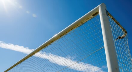 Bright sky behind soccer goal post and net on a sunny day