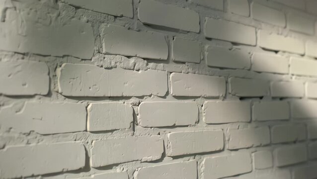 Close-up View of a White Painted Brick Wall Corner with Shadow Detail