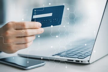 Person holding credit card near laptop with digital network overlay on light background, representing online payment and secure financial technology concept.