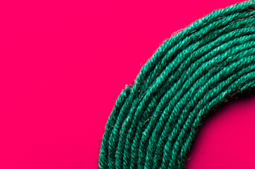 A solid background of colorful threads for cross stitch and needlework. Textured background for needlework and design. Rainbow of threads. Rows of colorful embroidery threads.