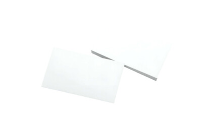 Two white rectangular objects, one atop a stack, isolated against a black backdrop