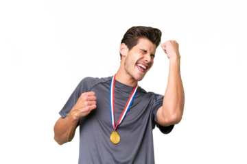 Young caucasian man with medals over isolated background celebrating a victory