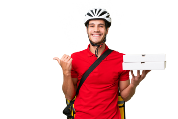 Pizza delivery man with work uniform picking up pizza boxes over isolated background pointing to the side to present a product
