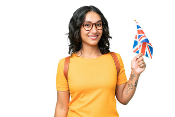 Young Argentinian woman holding an United Kingdom flag over isolated background smiling a lot