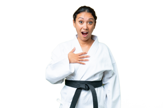 Young Uruguayan woman doing karate over isolated chroma key background surprised and shocked while looking right - Powered by Adobe
