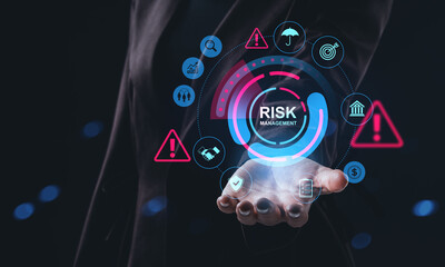 Businessman holding futuristic hologram interface showing risk management concept with warning signs, finance icons, and analytics symbols.
