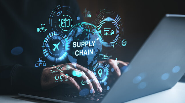 Digital supply chain management concept with futuristic hologram interface and logistics icons around globe on laptop screen in dark environment.