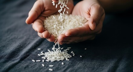 Hands Holding and Pouring White Rice Grains on Dark Fabric