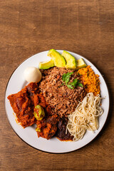 Waakye, Cooked Rice And Beans Served With Tomato Stew, Egg, Gari, Spaghetti, Avocado and Shito, Spicy Pepper Sauce. Africa Ghana Traditional Dish